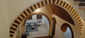 an archway leading into a room with a fireplace at Healing House in Luxor
