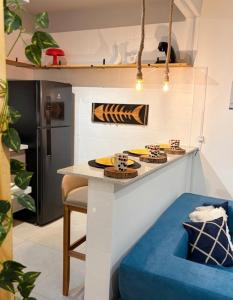 a kitchen with a table with some cakes on it at Apartamento Centro Bertioga Casal e Família - Ar Condicionado - Praia da Enseada in Bertioga