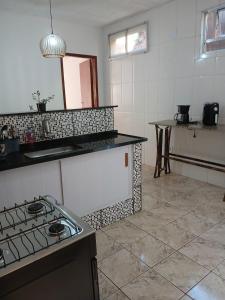 a kitchen with a stove and a counter top at Casa Progresso in Juiz de Fora