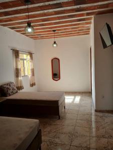 a bedroom with two beds and two windows at Casa Progresso in Juiz de Fora
