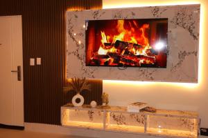 a fireplace in a living room with a fire place at Your Private Patio Oasis Spa Pool Lounge 2BR in Santiago de los Caballeros