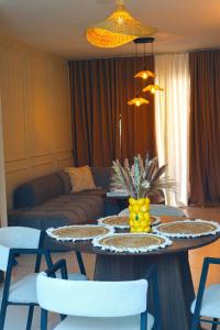 a living room with a table with chairs and a couch at Your Private Patio Oasis Spa Pool Lounge 2BR in Santiago de los Caballeros