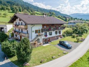 a house with a car parked in front of it at Kraftplatz am Litzlhof in Itter