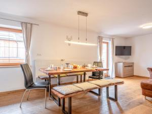 a kitchen and dining room with a table and chairs at Kraftplatz am Litzlhof in Itter