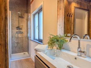 a bathroom with a sink and a shower at Seeperle in Afritz +33 photos