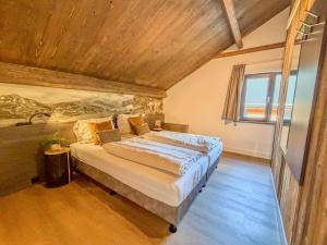 a bedroom with a large bed with a wooden ceiling at Seeperle in Afritz