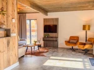 a living room with a couch and a tv at Seeperle in Afritz
