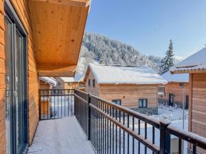 a balcony with a view of the snow covered mountains at Seeperle in Afritz