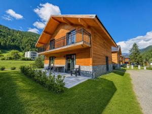a large wooden house with a gambrel roof at Gerlitzen Seealm in Afritz