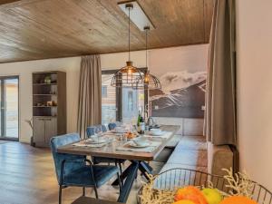 a dining room with a table and blue chairs at Gerlitzen Seealm in Afritz +36 photos