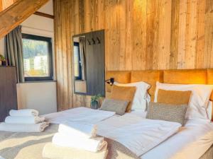 two beds in a room with wooden walls at Bergblick am Afritzer See in Afritz