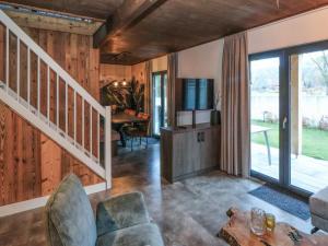 a living room with a staircase and a living room with a table at Bergblick am Afritzer See in Afritz