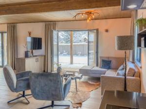 a living room with a couch and a table at Bergblick am Afritzer See in Afritz