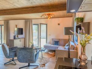 a living room with a couch and a table at Alpenchalet am See in Afritz