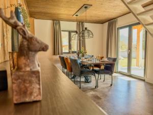 a dining room with a table and a deer head on the counter at Alpenchalet Kärntnerglück in Afritz