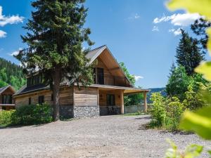 a house in the mountains with a gravel driveway at Alpenchalet Kärntnerglück in Afritz
