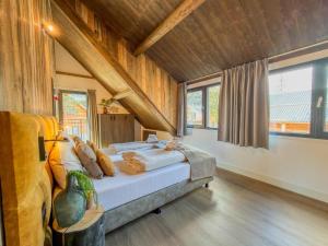 a bedroom with a bed in a room with wooden ceilings at Alpenchalet Kärntnerglück in Afritz
