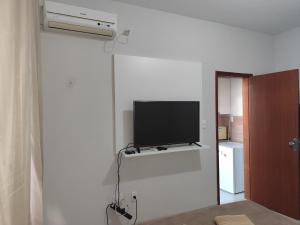 a living room with a flat screen tv on a wall at apartment work centro in Ubá