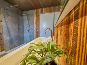 a bathroom with a tub and a plant at Afritz am See in Afritz