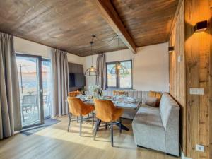 a dining room with a table and a couch at Verditzblick in Afritz