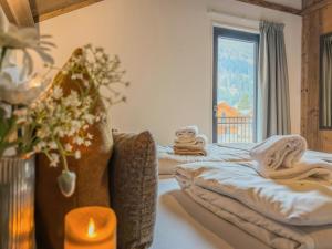 a room with two beds with towels and a candle at Verditzblick in Afritz