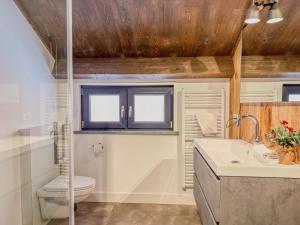 a bathroom with a toilet and a sink at Verditzblick in Afritz +33 photos