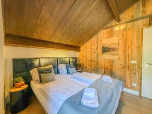 a bedroom with two beds in a room with wooden walls at Seechalet Afritz in Afritz