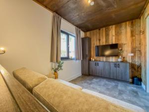a living room with a couch and a flat screen tv at Berg und See in Afritz