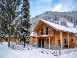 a log cabin in the snow with trees at Berg und See in Afritz
