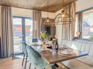 a dining room with a wooden table and chairs at Seechalet Afritz in Afritz +31 photos