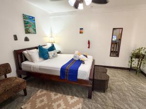 a bedroom with a bed with two stuffed animals on it at Caribbean Shores Belize in Hopkins +202 photos