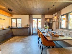 a dining room with a long table and chairs at Mirnockblick in Afritz