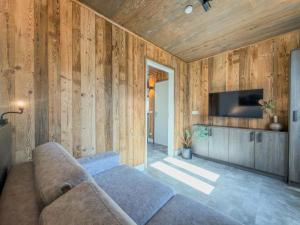 a living room with a couch and a tv at Mirnockblick in Afritz