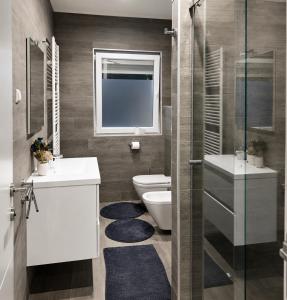 a bathroom with a toilet and a sink and a shower at NOVA residence in Sarajevo