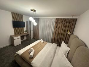 a hotel room with a bed and a couch at Casa DAIANA in Moisei +219 photos