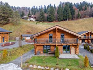 a log home with a large deck on a hill at Jenig 2B in Jenig