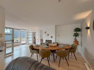 a living room with a wooden table and chairs at Zicht op Valkenburg in Schin op Geul