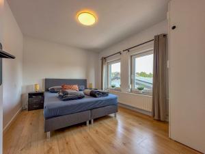 a bedroom with a bed and a large window at Zicht op Valkenburg in Schin op Geul +25 photos