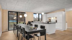 a kitchen and dining room with a table and chairs at Villavilla 581 - Gjerrild, Østjylland in Grenå