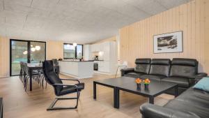 a living room with a couch and a table at Villavilla 581 - Gjerrild, Østjylland in Grenå +14 photos