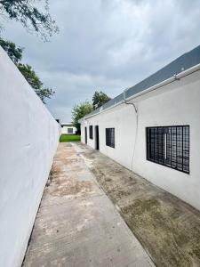an alleyway between two white buildings at Depas Expo Estadio in Monterrey