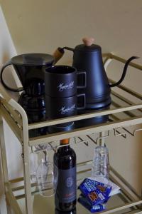 a shelf with two cups and a coffee maker on it at Magnetic Hill Winery in Moncton