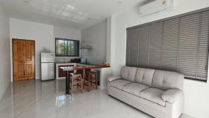 a living room with a couch and a kitchen at Green Mountain View villas Koh samui in Plai Laem +4 photos