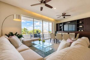 a living room with a couch and a table at Sunset Condo 104 Puerta al Mar Isla Mujeres Mexico in Isla Mujeres