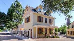 a large yellow house with a fence in front of it at Lewis Loft by AvantStay in Paso Robles