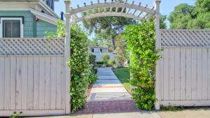 a wooden gate with an arch in front of a house at Hustons Attic by AvantStay in Paso Robles +4 photos