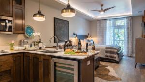 a kitchen with a sink and a bed in a room at Paso Park Suites by AvantStay in Paso Robles