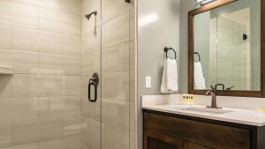 a bathroom with a shower and a sink and a mirror at Paso Park Suites by AvantStay in Paso Robles +18 photos