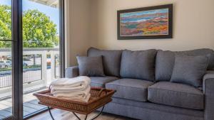 a living room with a couch and a balcony at The Top Shelf by AvantStay in Paso Robles
