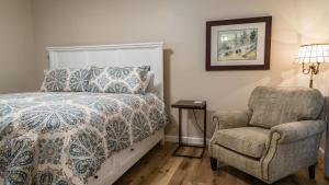 a bedroom with a bed and a chair at The Top Shelf by AvantStay in Paso Robles